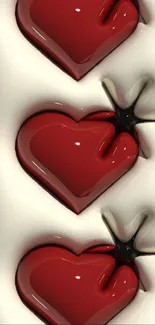 Glossy red heart shapes with cream background.