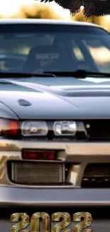 Sleek metallic sports car with 2022 emblem and eagle above.