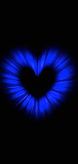 Blue heart glow on black background.