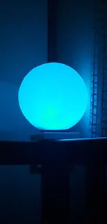 Glowing blue sphere on a dark background.