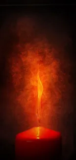 Glowing red candle with vibrant flame against dark background.