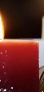 Close-up of a glowing candle flame, creating warmth.