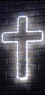 Glowing neon cross on a brick wall, perfect for a spiritual-themed wallpaper.