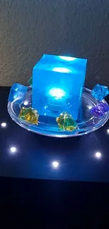 A glowing blue cube with colorful gem accents on a dark background.