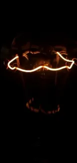 Glowing light bulb filament in darkness