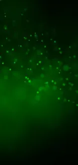 A glowing green abstract mobile wallpaper with ethereal light sparkles.