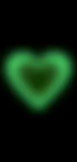 Mobile wallpaper with a glowing green heart on black background.