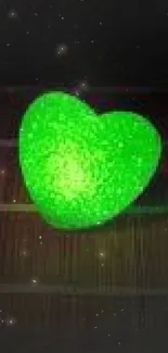 Glowing green heart on dark background wallpaper.