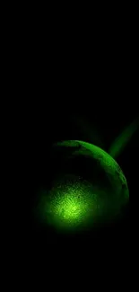 Glowing green orb with dark background wallpaper.