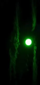 Mysterious glowing green orb in dark wallpaper.