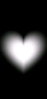 Glowing white heart on a black background wallpaper.