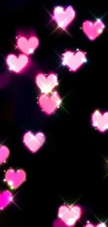 Glowing pink hearts on black background wallpaper.