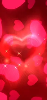 Glowing heart mobile wallpaper with red and pink hues and sparkling effects.