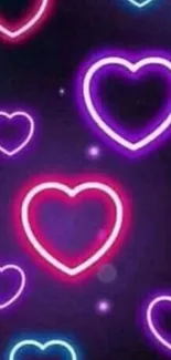 Neon hearts glowing in dark purple background.