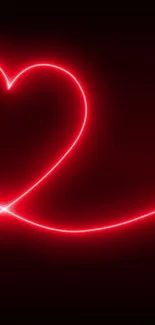 Neon red heart glowing on black background.