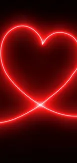 Vibrant red neon heart glowing on dark background.