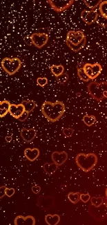 Mobile wallpaper featuring glowing hearts on a dark red background with golden speckles.