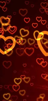 Mobile wallpaper with glowing heart patterns in red and orange hues.