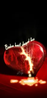 A glowing red heart cracked with light on a dark background.