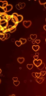 Orange glowing hearts on a dark background wallpaper.