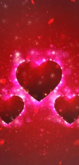 Vibrant red and pink glowing hearts wallpaper with sparkling effects.