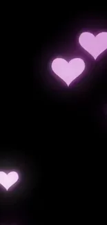 Glowing pink hearts on a black background.