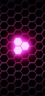 Pink glowing hexagon on dark patterned background wallpaper.