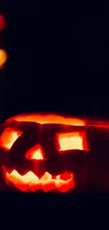 Eerie glowing jack-o'-lantern against dark background, capturing Halloween spirit.