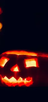 Glowing Jack-O'-Lantern with dark background.