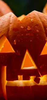 Glowing Jack-o'-lantern amid pumpkins, perfect for Halloween.