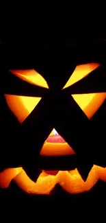 A glowing Jack-O'-Lantern with an orange hue against a dark background.