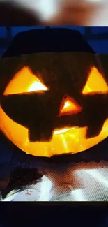 Glowing Jack-O'-Lantern on dark background, perfect for Halloween vibe.