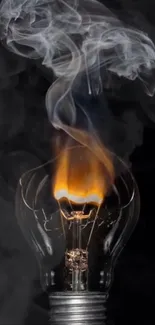 Glowing lightbulb with smoke rising above it.