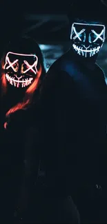 Two people wearing glowing masks in a dark alley.
