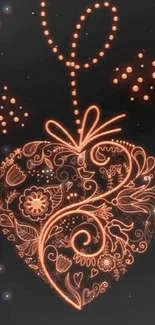 Ornate heart design in glowing orange on black background.