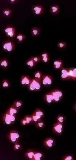 Glow pink hearts on black background wallpaper.