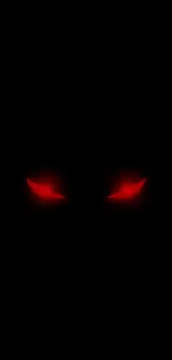 Mysterious wallpaper with glowing red eyes on black background.