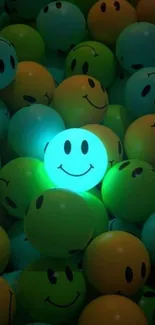 Glowing teal smiley face balloons in a pile.