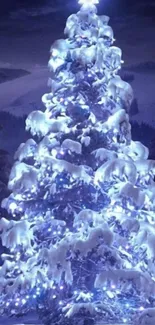 Snowy Christmas tree glowing with blue lights.