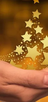 A hand holding glowing stars against a golden background.