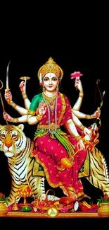 Goddess Durga art with multiple arms on a tiger against black background.