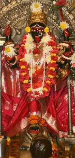 Vibrant image of Goddess Kali with red attire and floral decorations.