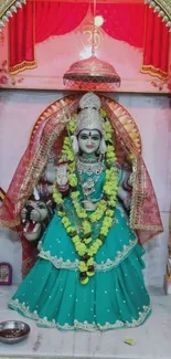 Vibrant goddess statue in a shrine.