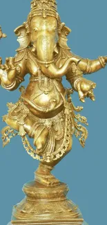 Golden Ganesha statue with a blue background for mobile wallpaper.