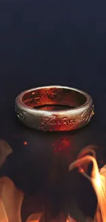 A gold ring encircled by vibrant flames on a dark background.