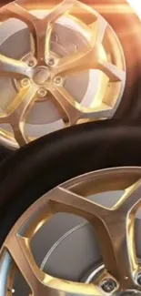 Golden alloy wheel with sunlight on mobile wallpaper.