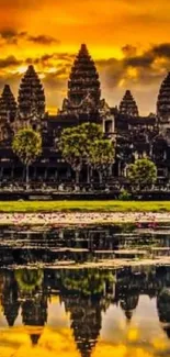 Angkor Wat at sunset reflected in water with golden sky.