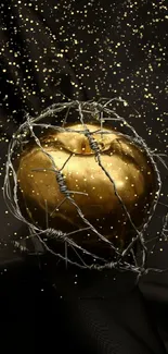 Golden apple wrapped in barbed wire with sparkling black background.