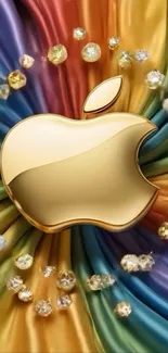 Golden apple logo on colorful silk background with jewels.