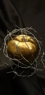 Golden apple entwined in barbed wire on a dark background.